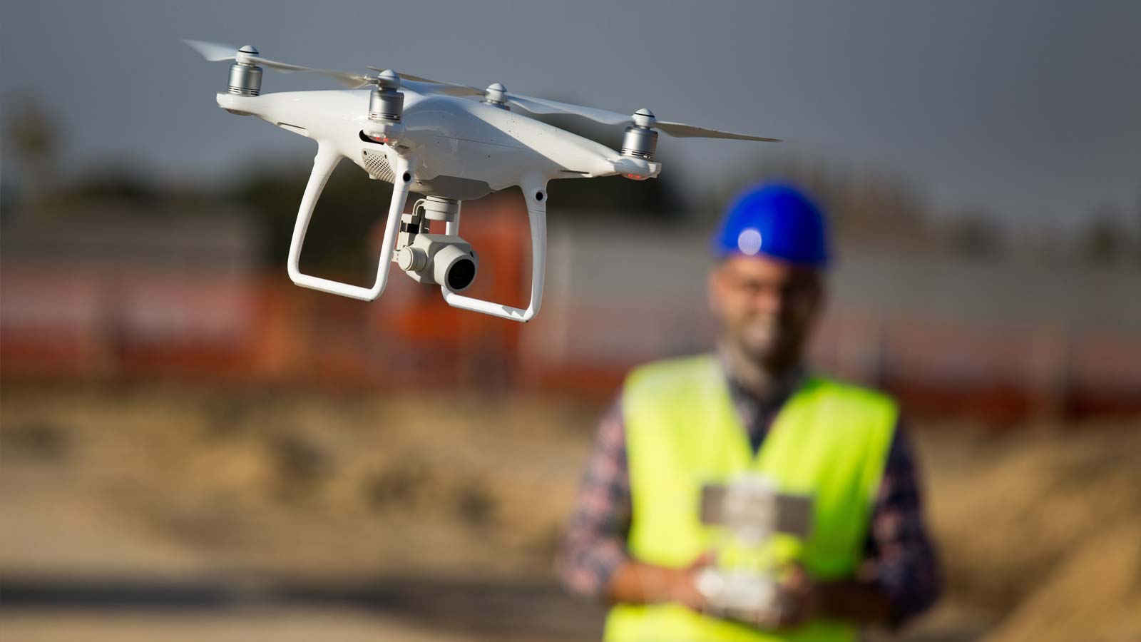 Professional drone pilot flying DJI drone on location